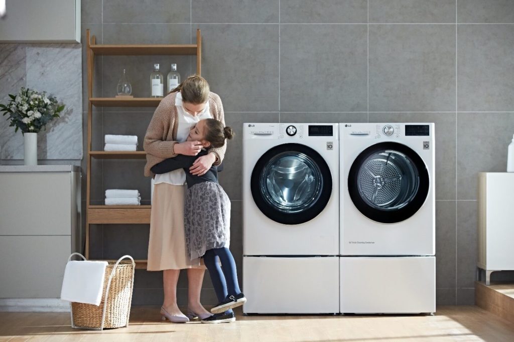 A couple of women looking at a washing machine

Description automatically generated with low confidence